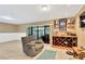 Open-concept living area featuring sliding doors to the patio, a bar, and a comfortable recliner at 1710 Orange Hill Way, Brandon, FL 33510