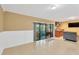 Living room with tile floors and sliding glass door to patio, open to kitchen with breakfast bar at 1710 Orange Hill Way, Brandon, FL 33510