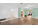 Open-concept living area with wood floors and doorways to the kitchen and dining room at 1710 Orange Hill Way, Brandon, FL 33510