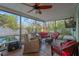 Comfortable screened in porch with wicker furniture and a ceiling fan overlooking the backyard at 1710 Orange Hill Way, Brandon, FL 33510