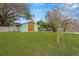 Spacious and well-kept side yard with lush green grass, enclosed by a white fence for privacy at 1710 Orange Hill Way, Brandon, FL 33510