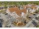 An aerial view of stucco townhomes with tile roofs and mature trees at 17978 Villa Creek Dr, Tampa, FL 33647