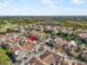 Aerial view of townhomes community with a small pond and lush green surroundings at 17978 Villa Creek Dr, Tampa, FL 33647