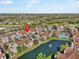 An aerial view showcases a serene pond with a fountain and community pool with neighborhood at 17978 Villa Creek Dr, Tampa, FL 33647