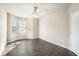 Sunlit bedroom featuring a ceiling fan, wood floors, and a bay window at 17978 Villa Creek Dr, Tampa, FL 33647