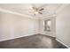 Spacious bedroom with wood floors, large window, and a ceiling fan at 17978 Villa Creek Dr, Tampa, FL 33647