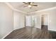 Bedroom with wood floors and a view of a bathroom and a walk-in closet at 17978 Villa Creek Dr, Tampa, FL 33647