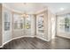 Bright dining nook featuring hardwood floors, a chandelier, and large windows at 17978 Villa Creek Dr, Tampa, FL 33647
