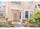 Close-up view of a condo front door with a covered porch and well-maintained landscaping at 17978 Villa Creek Dr, Tampa, FL 33647