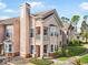 Charming multi-story townhome with balcony, lush landscaping, and inviting entrance at 17978 Villa Creek Dr, Tampa, FL 33647