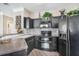 Modern kitchen with black cabinets, stainless steel appliances, and stylish backsplash at 17978 Villa Creek Dr, Tampa, FL 33647