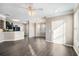 Bright living space featuring hardwood floors, ceiling fan, and an open layout leading to kitchen at 17978 Villa Creek Dr, Tampa, FL 33647