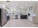 Spacious kitchen with white cabinets, stainless steel appliances, light floors, and lots of natural light at 1817 E Calhoun St, Plant City, FL 33563