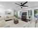 Spacious living room with dark hardwood floors, white furniture, and natural lighting through multiple windows at 222 11Th N Ave, St Petersburg, FL 33701