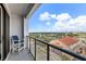 Enjoy the city view from this condo balcony with clear railings and a comfortable chair at 226 5Th N Ave # 901, St Petersburg, FL 33701
