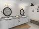 Bathroom featuring double sinks, granite countertops, modern fixtures and decorative mirrors at 226 5Th N Ave # 901, St Petersburg, FL 33701