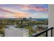 Expansive city views with a colorful sunset from a balcony overlooking the neighborhood and nearby ocean at 226 5Th N Ave # 901, St Petersburg, FL 33701