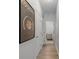 Hallway features wood flooring, access to laundry room, and decorative 'cocktails' poster at 226 5Th N Ave # 901, St Petersburg, FL 33701