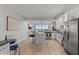 Bright, open-concept kitchen featuring modern stainless steel appliances, a breakfast bar, and hardwood floors at 226 5Th N Ave # 901, St Petersburg, FL 33701