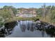 Aerial shot of a community pool, tennis court and picturesque lake creating a serene atmosphere at 2460 Oakleaf Dr, Clearwater, FL 33763