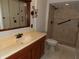 Updated bathroom with a glass enclosed shower, a vanity with drawers, and a mirror at 2460 Oakleaf Dr, Clearwater, FL 33763