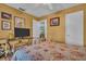 Cozy bedroom features wood-look flooring, a decorative console table, and warm, inviting wall colors at 25 Windrush Bay Dr # 25, Tarpon Springs, FL 34689