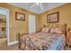 Comfortable bedroom with a vintage metal frame bed and painted yellow walls at 25 Windrush Bay Dr # 25, Tarpon Springs, FL 34689