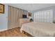 Bright bedroom featuring light blue walls, wood-look floors, plantation shutters, and a clean, airy feel at 25 Windrush Bay Dr # 25, Tarpon Springs, FL 34689