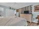 Comfortable bedroom showcasing light blue walls, wood-look floors, ample natural light, and calming decor at 25 Windrush Bay Dr # 25, Tarpon Springs, FL 34689