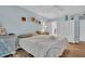 Comfortable bedroom with light blue walls, hardwood floors, and closet at 25 Windrush Bay Dr # 25, Tarpon Springs, FL 34689