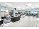 Spacious community room with multiple seating areas, ceiling fans, and views of the outdoor area at 25 Windrush Bay Dr # 25, Tarpon Springs, FL 34689