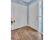 Inviting entryway with wood-look flooring, white door, vertical blinds and frosted glass pane for natural light at 25 Windrush Bay Dr # 25, Tarpon Springs, FL 34689