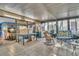 Bright sunroom/lanai with tiled flooring and large windows at 25 Windrush Bay Dr # 25, Tarpon Springs, FL 34689