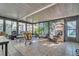 Enclosed Florida room featuring tiled flooring and lots of natural light at 25 Windrush Bay Dr # 25, Tarpon Springs, FL 34689