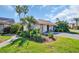 Charming home with a well-manicured lawn and lush tropical landscaping at 25 Windrush Bay Dr # 25, Tarpon Springs, FL 34689