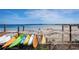 Colorful kayaks on a rack at the beach, with a view of the calm ocean at 25 Windrush Bay Dr # 25, Tarpon Springs, FL 34689