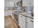 Updated kitchen with stainless steel appliances, white cabinets, and tile backsplash at 25 Windrush Bay Dr # 25, Tarpon Springs, FL 34689