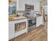 Updated kitchen with stainless steel appliances, white cabinets, and tile backsplash at 25 Windrush Bay Dr # 25, Tarpon Springs, FL 34689
