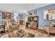 Comfortable living room featuring blue walls, hardwood floors, and relaxing furniture at 25 Windrush Bay Dr # 25, Tarpon Springs, FL 34689