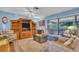 Comfortable living room featuring a large window and built-in shelving unit at 25 Windrush Bay Dr # 25, Tarpon Springs, FL 34689