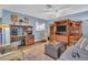 Spacious living room with blue walls, ceiling fan, and built in shelving at 25 Windrush Bay Dr # 25, Tarpon Springs, FL 34689