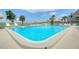 Beautiful outdoor pool with clear blue water and plenty of space for lounging at 25 Windrush Bay Dr # 25, Tarpon Springs, FL 34689
