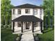 Charming two-story home featuring a covered porch, black framed windows, and well manicured landscaping at 2711 13Th N St, St Petersburg, FL 33704