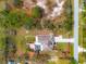 Stunning aerial view of the property, featuring a pool, well-manicured landscaping, and a spacious yard at 27930 Ravens Brook Rd, Wesley Chapel, FL 33544