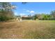 Large backyard featuring a patio, screened-in pool, and mature trees at 27930 Ravens Brook Rd, Wesley Chapel, FL 33544
