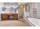 Elegant primary bathroom with large vanity, soaking tub, and glass shower at 27930 Ravens Brook Rd, Wesley Chapel, FL 33544