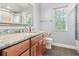 Bathroom features a granite vanity with a sink, toilet, and mirror at 27930 Ravens Brook Rd, Wesley Chapel, FL 33544