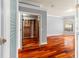 Large bedroom featuring hardwood floors and walk-in closet with custom wood shelving at 27930 Ravens Brook Rd, Wesley Chapel, FL 33544