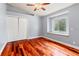 Bedroom with light gray walls, wood floors, closet, a ceiling fan, and a built-in seat under the window at 27930 Ravens Brook Rd, Wesley Chapel, FL 33544