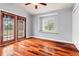 Bright bedroom with beautiful hardwood floors, natural light, and french doors to outdoor scenery at 27930 Ravens Brook Rd, Wesley Chapel, FL 33544